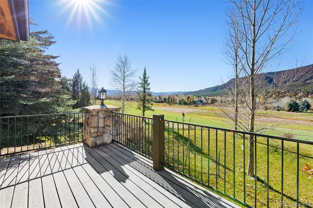 a view of balcony with wooden floor and fence