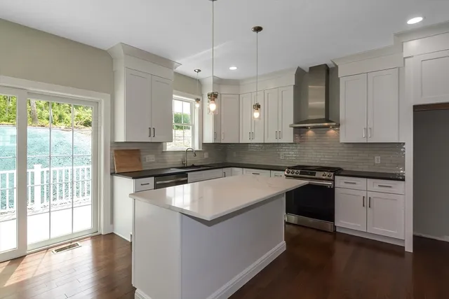 a kitchen with granite countertop white cabinets and white appliances