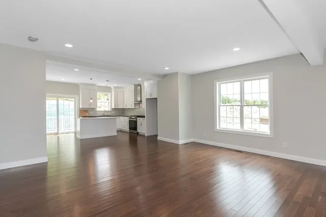 a large kitchen with granite countertop a stove a sink and a granite counter top