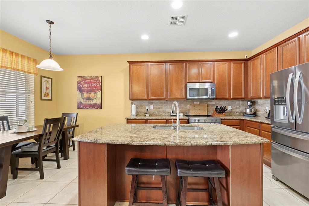 13243 Charfield Street Windermere, FL 34786 - Photo 18 of 39 a kitchen with a table chairs sink and cabinets