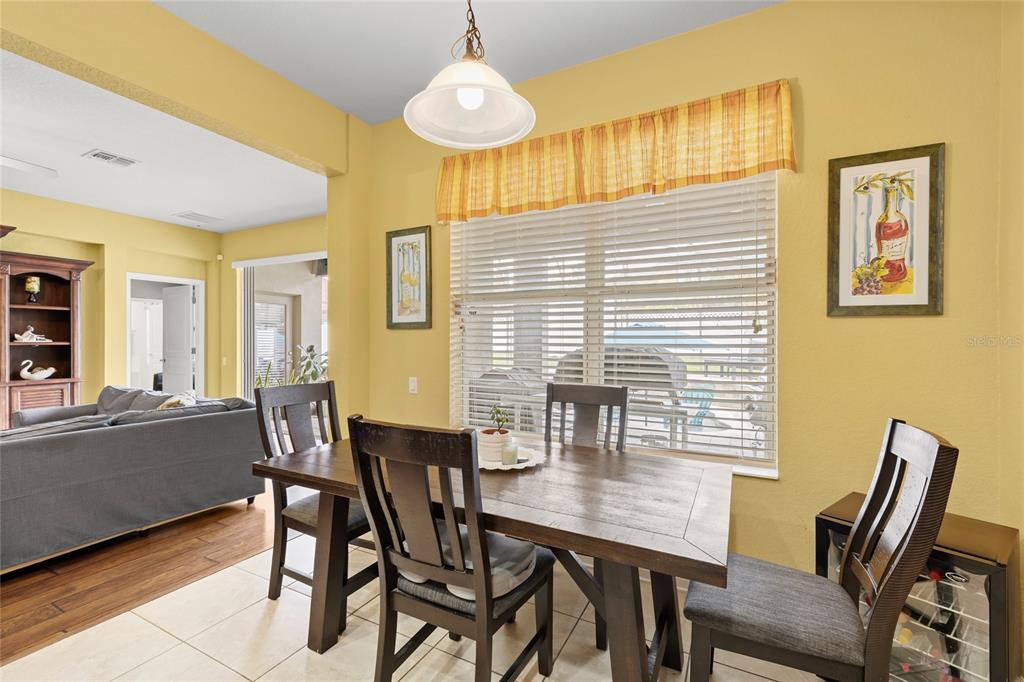 13243 Charfield Street Windermere, FL 34786 - Photo 19 of 39 a view of a dining room with furniture and wooden floor