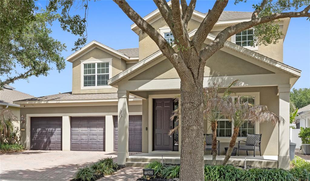 13243 Charfield Street Windermere, FL 34786 - Photo 2 of 39 a front view of a house with a tree