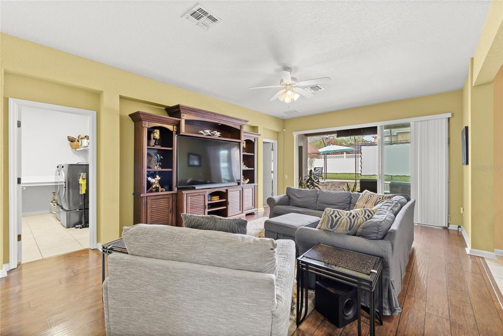 13243 Charfield Street Windermere, FL 34786 - Photo 22 of 39 a living room with furniture a ceiling fan and a flat screen tv