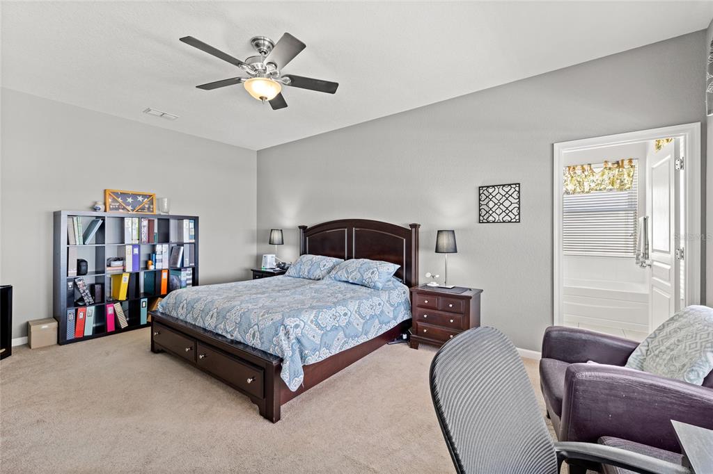 13243 Charfield Street Windermere, FL 34786 - Photo 23 of 39 a living room with a bed furniture and a book shelf