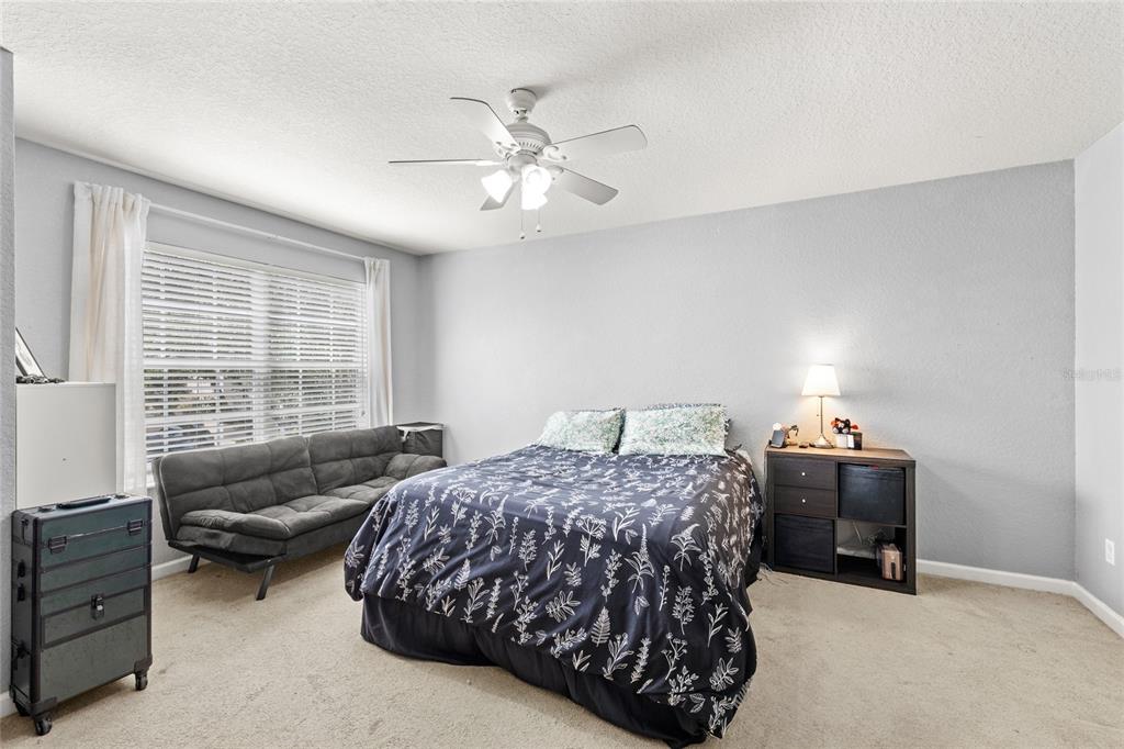 13243 Charfield Street Windermere, FL 34786 - Photo 28 of 39 a bedroom with a bed and a couch