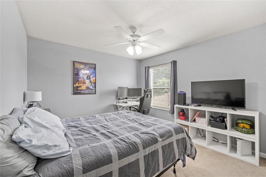 13243 Charfield Street Windermere, FL 34786 - Photo 30 of 39 a bedroom with a bed and a flat screen tv