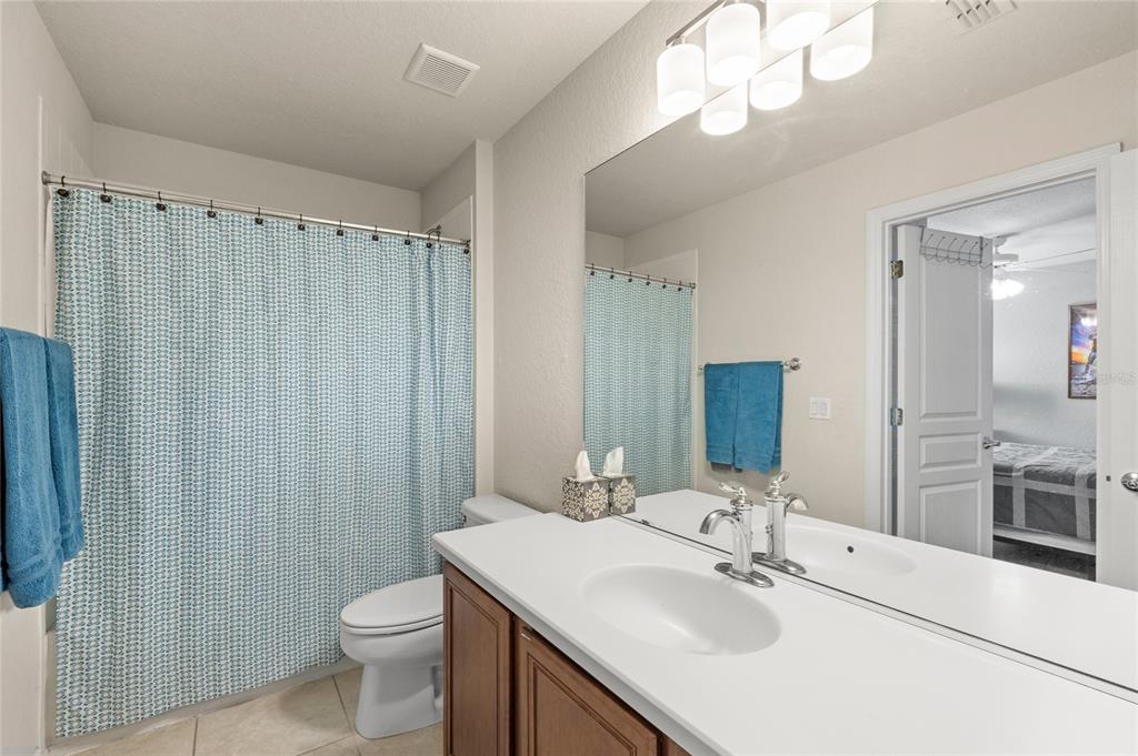 13243 Charfield Street Windermere, FL 34786 - Photo 31 of 39 a bathroom with a sink vanity mirror and toilet