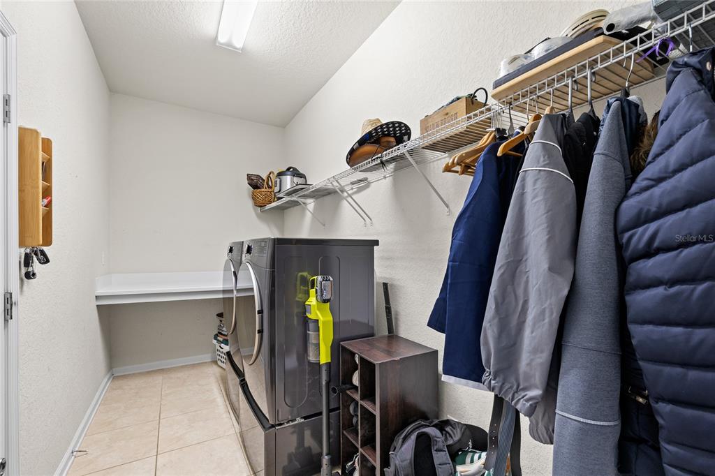 13243 Charfield Street Windermere, FL 34786 - Photo 34 of 39 a view of walk in closet with clothes and shoes
