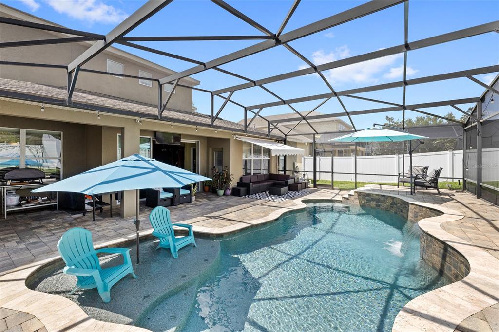 13243 Charfield Street Windermere, FL 34786 - Photo 9 of 39 a view of a patio with a table and chairs under an umbrella