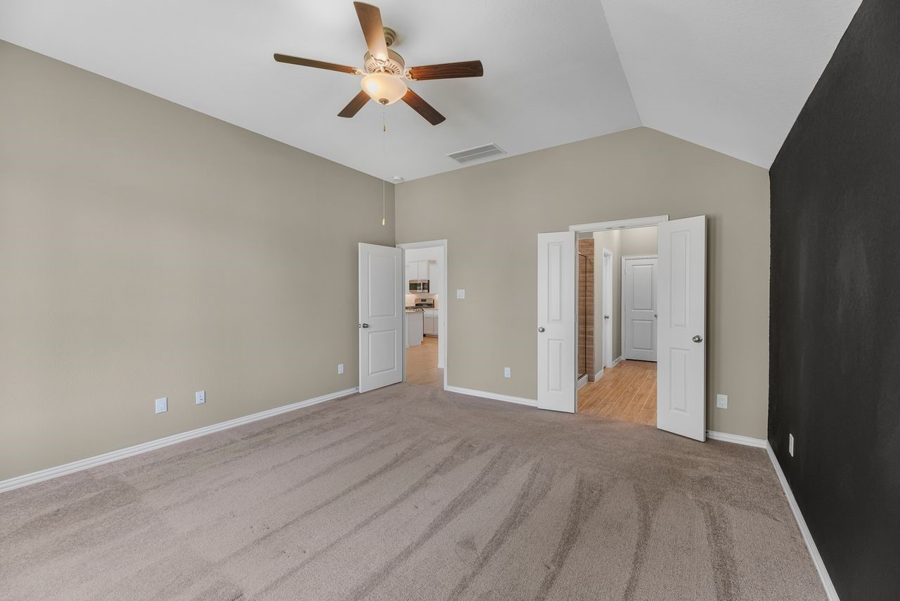 21714 Grayson Highlands Way Porter, TX 77365 - Photo 13 of 27 an empty room with closet and a ceiling fan