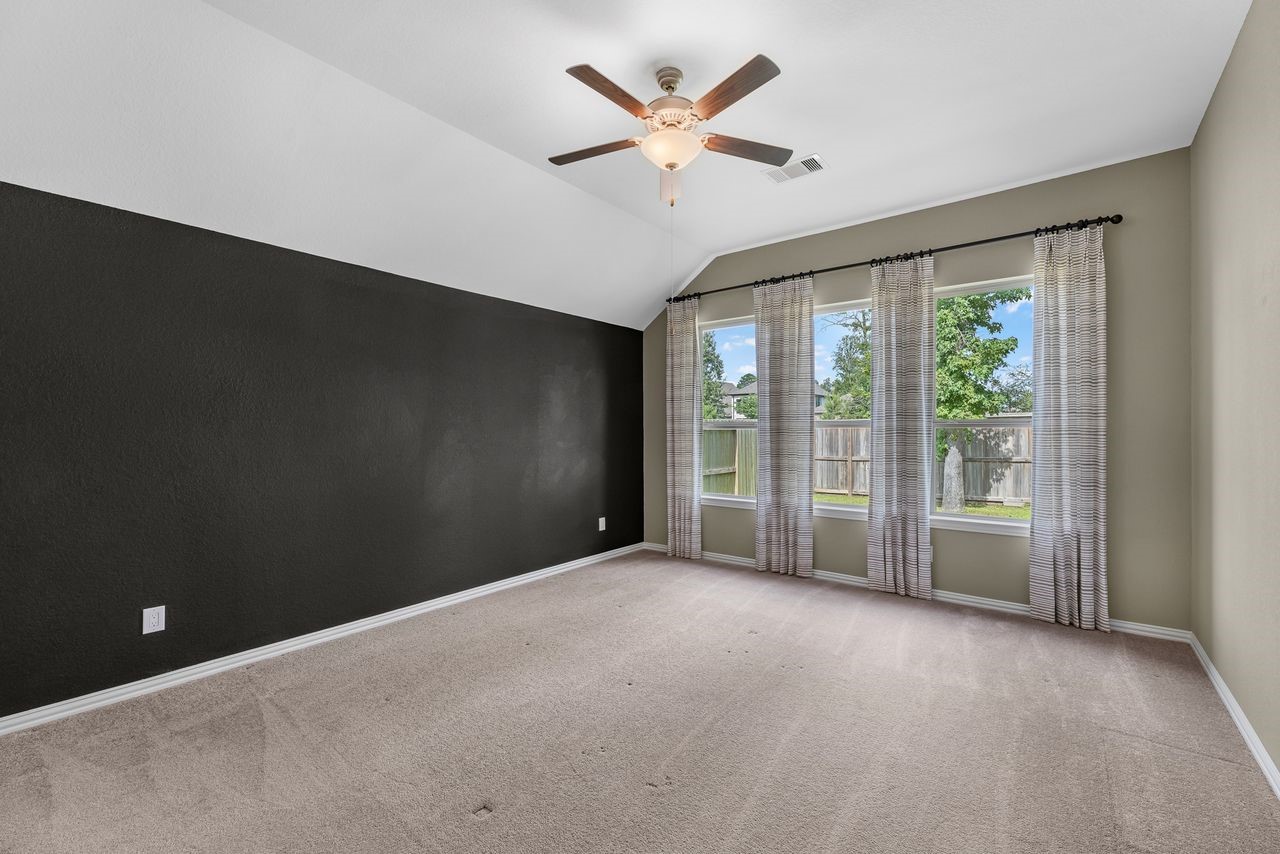 21714 Grayson Highlands Way Porter, TX 77365 - Photo 14 of 27 a view of a livingroom with a ceiling fan and window