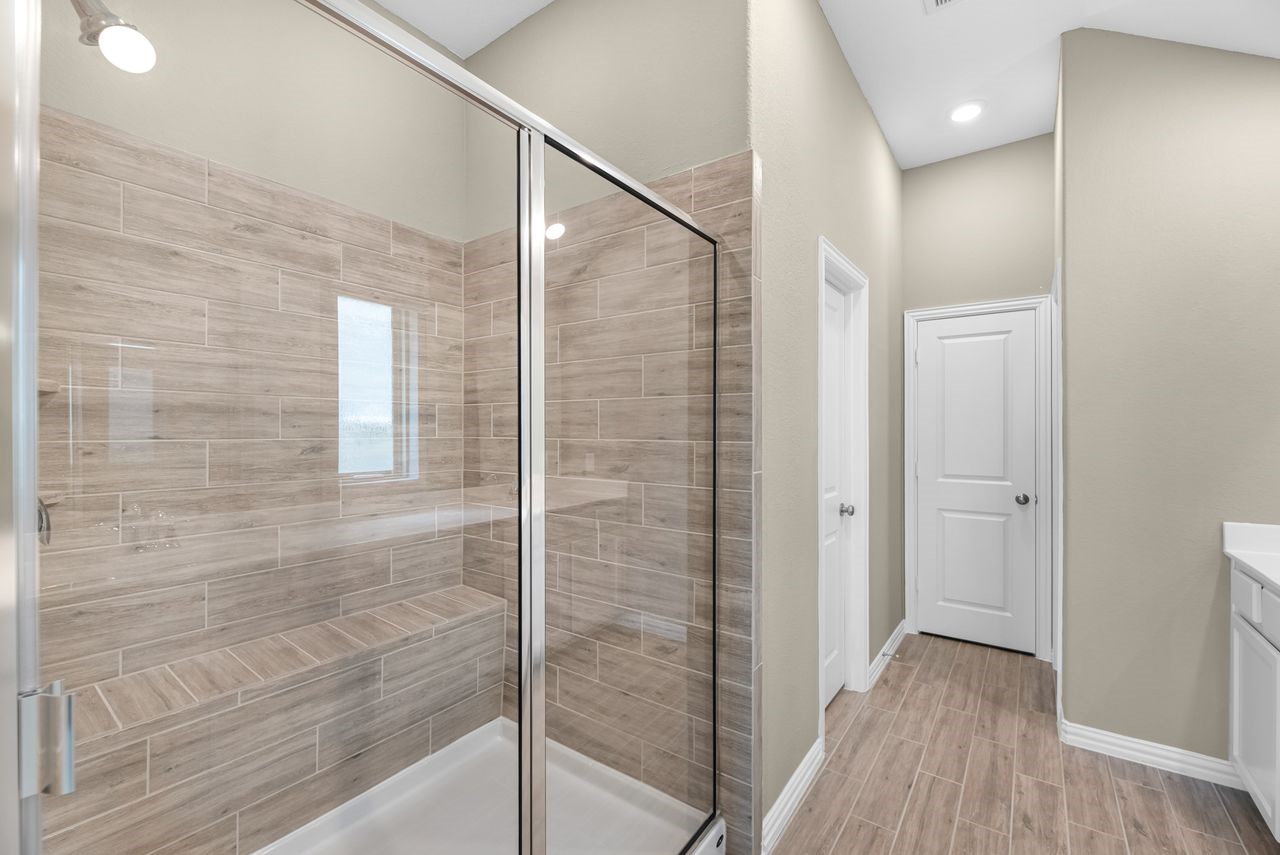 21714 Grayson Highlands Way Porter, TX 77365 - Photo 17 of 27 a bathroom with a shower and a glass door