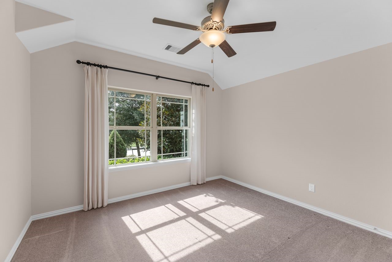 21714 Grayson Highlands Way Porter, TX 77365 - Photo 18 of 27 an empty room with chandelier fan and windows