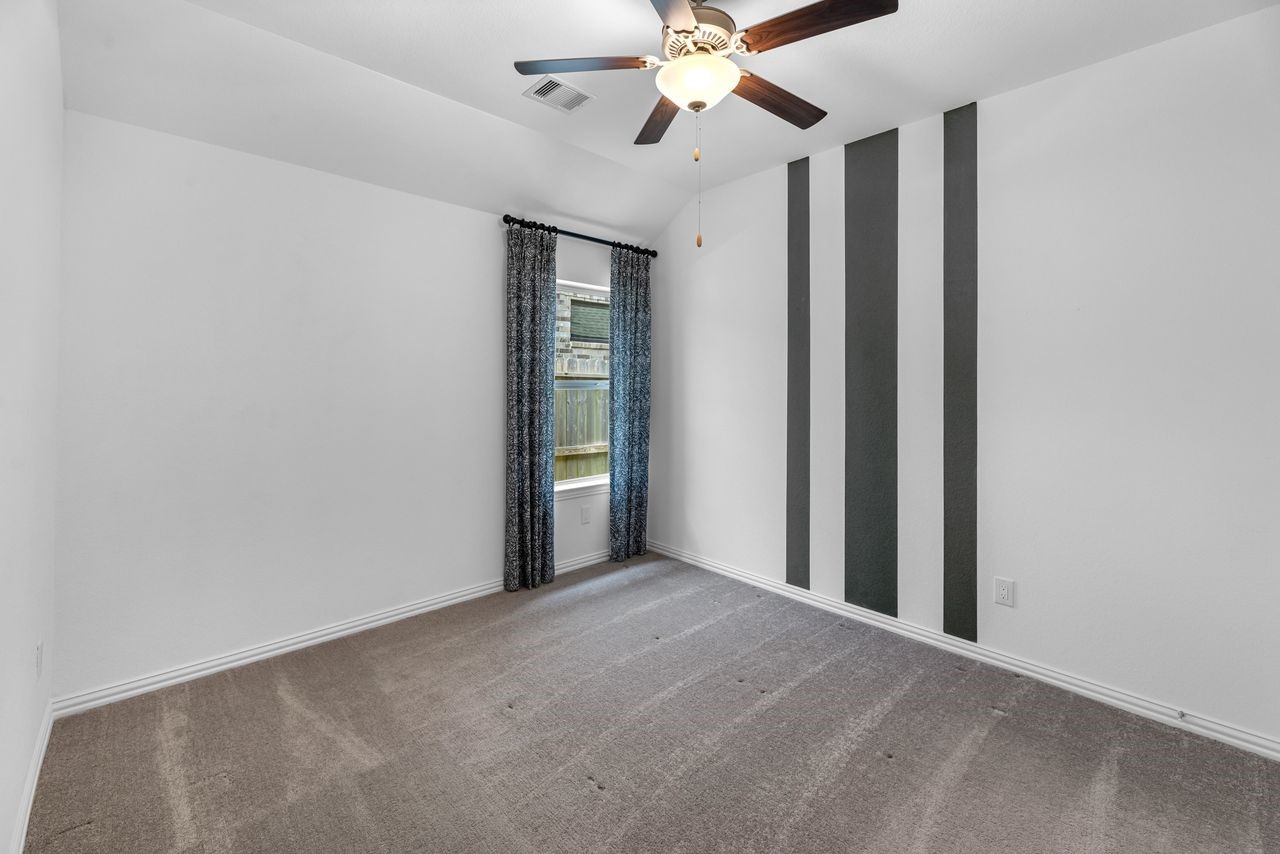 21714 Grayson Highlands Way Porter, TX 77365 - Photo 21 of 27 a view of an empty room with a chandelier fan