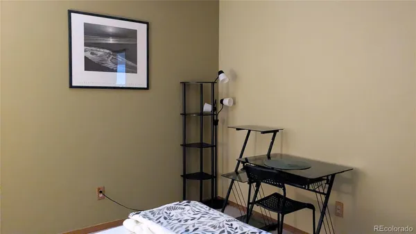 a bedroom with a bed and a mirror