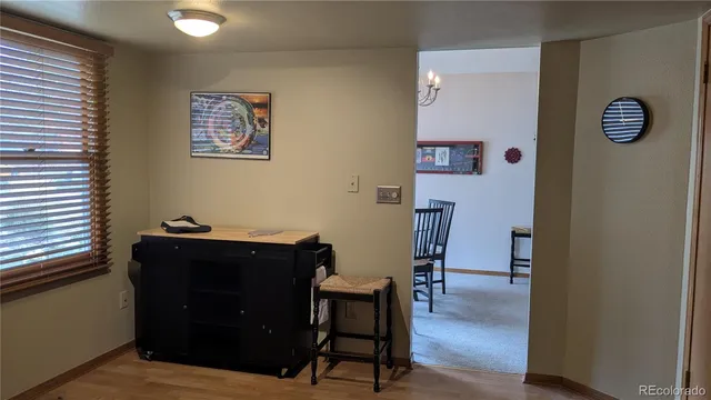 a view of a workspace with furniture and wooden floor