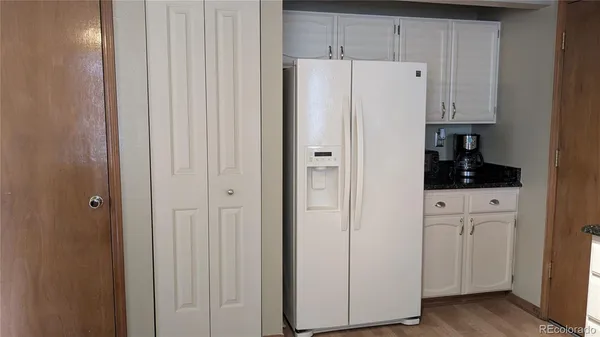 a white cabinet sitting in a kitchen
