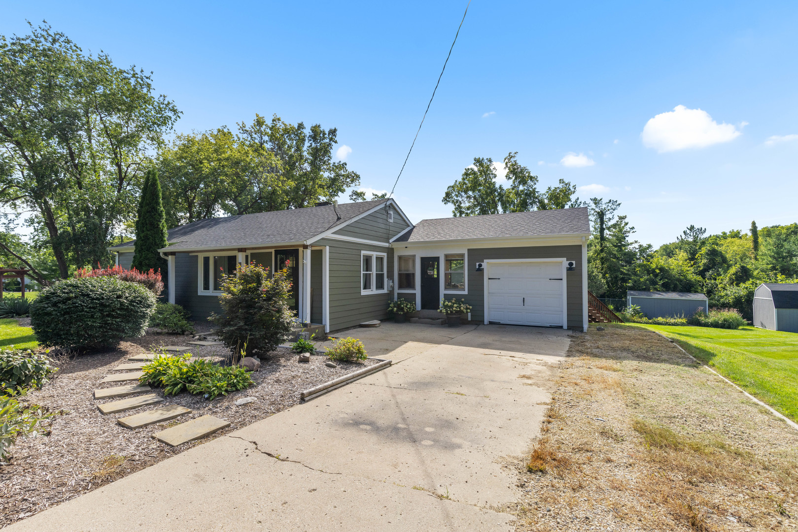 2019 Hawthorn Road Marengo, IL 60152 - Photo 2 of 24 a front view of a house with a garden and outdoor seating
