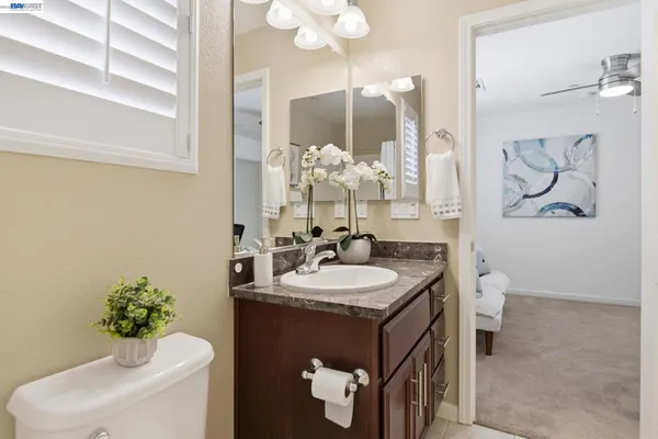 a bathroom with a toilet sink and mirror