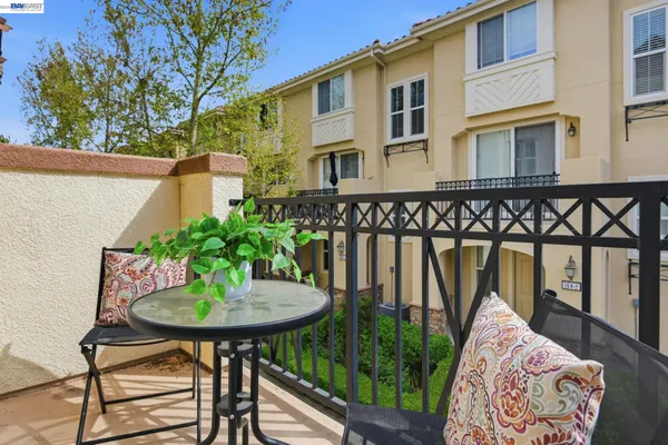 a backyard of a house with table and chairs