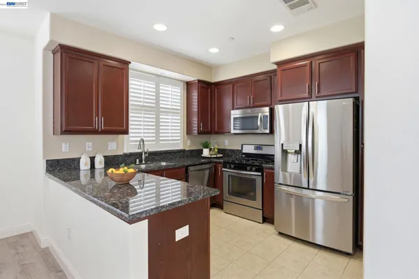 a kitchen with a refrigerator sink and microwave