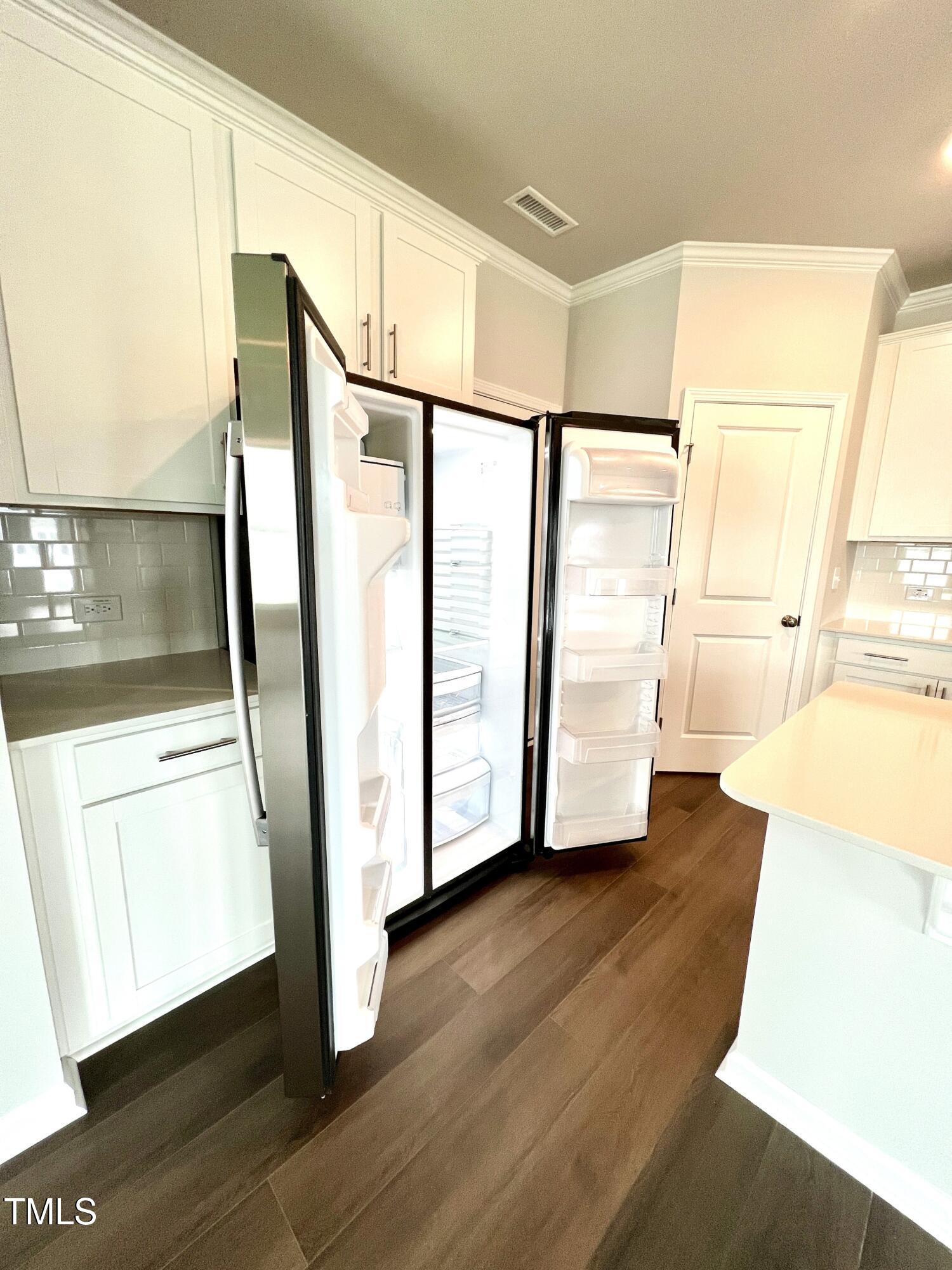 429 Lily Grv Loop Raleigh, NC 27610 - Photo 11 of 32 a view of front door with wooden floor