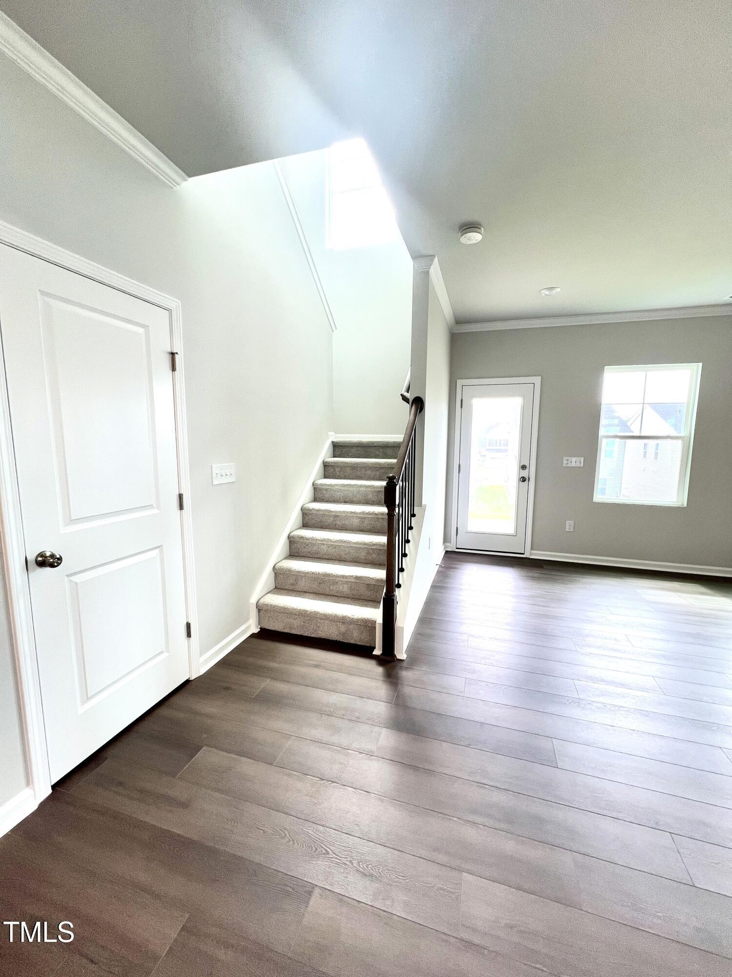 429 Lily Grv Loop Raleigh, NC 27610 - Photo 16 of 32 wooden floor in an empty room with a window