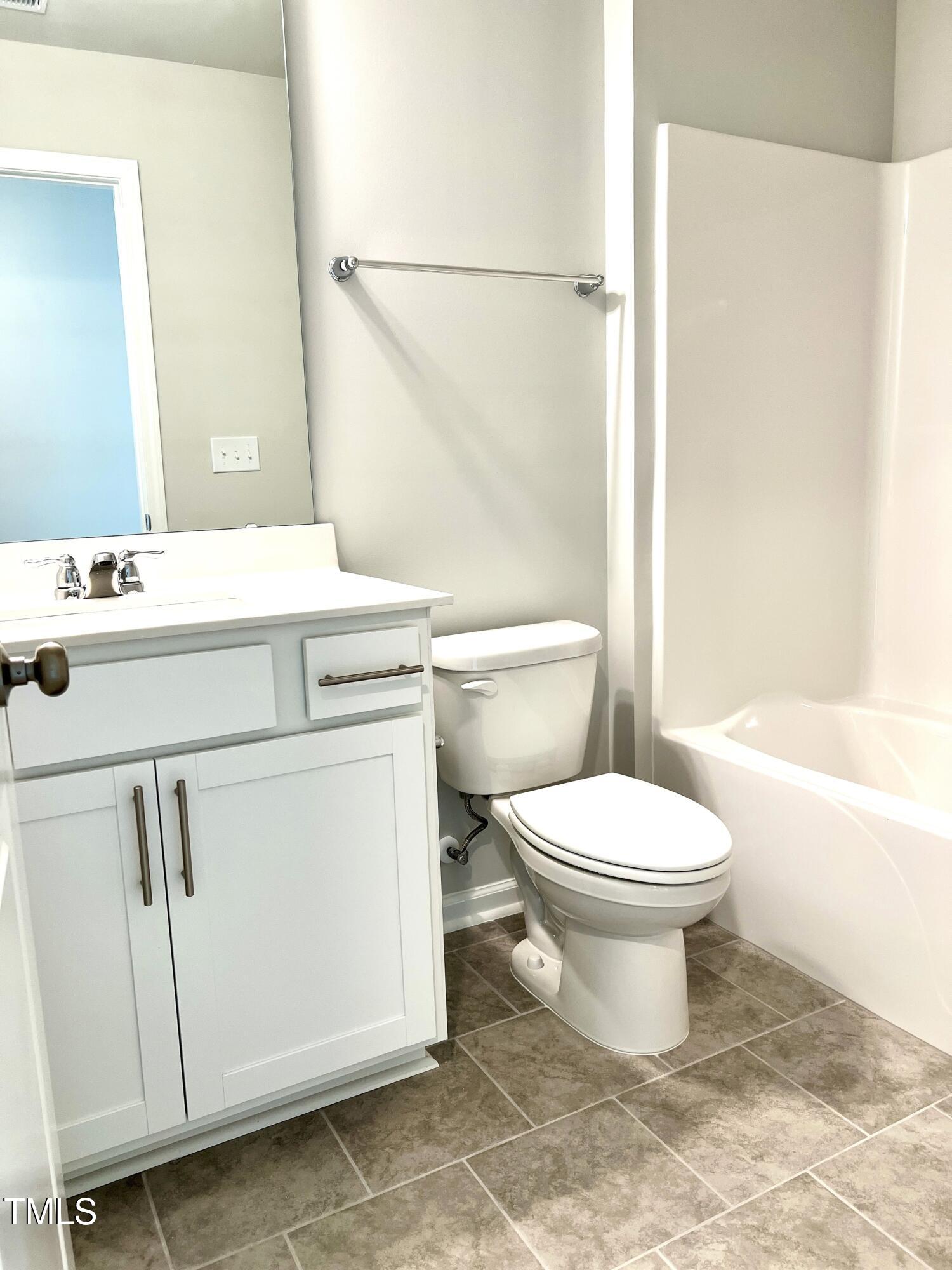 429 Lily Grv Loop Raleigh, NC 27610 - Photo 21 of 32 a bathroom with a toilet a sink and a bathtub