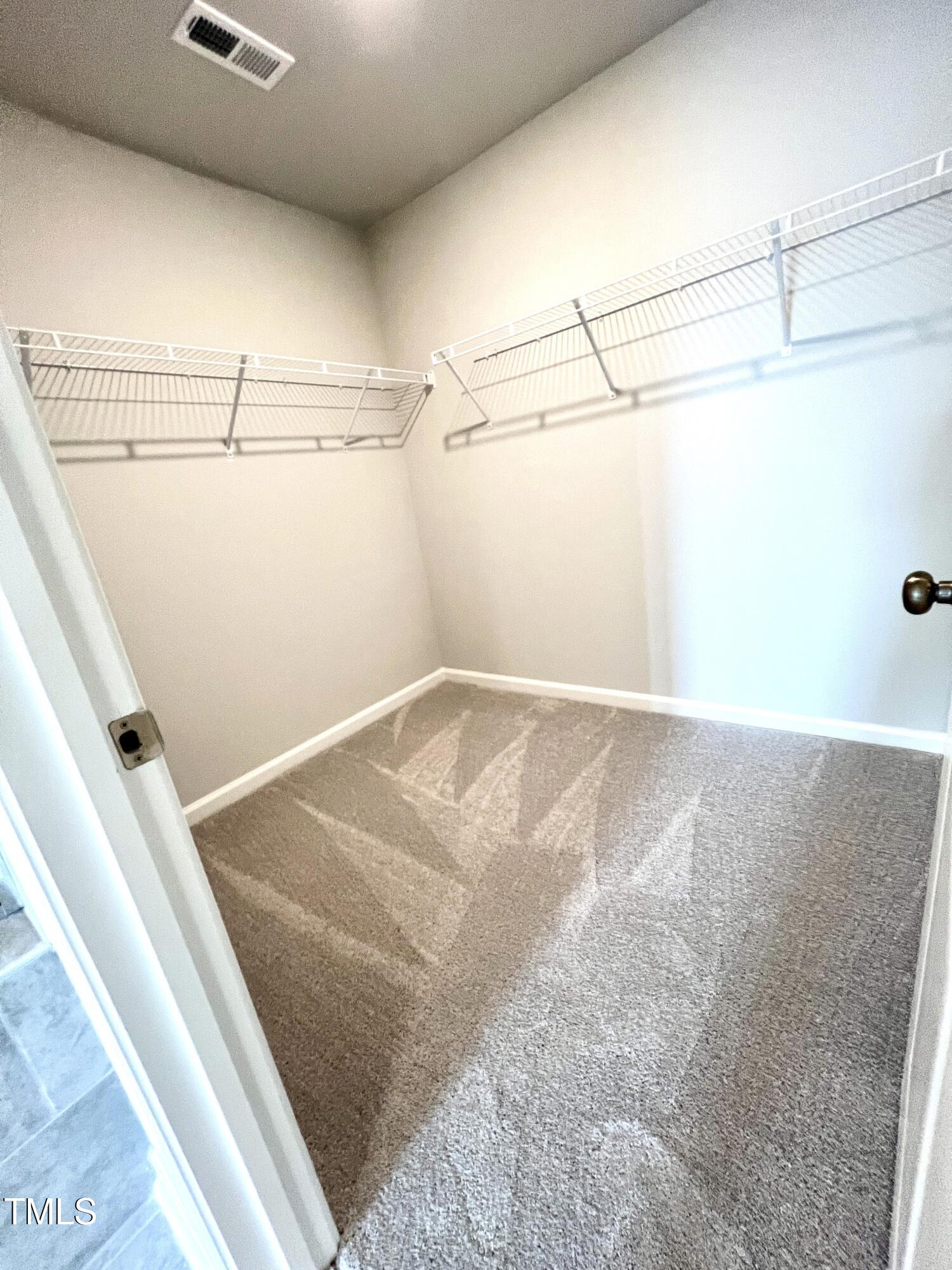 429 Lily Grv Loop Raleigh, NC 27610 - Photo 25 of 32 a view of a room with racks on the wall