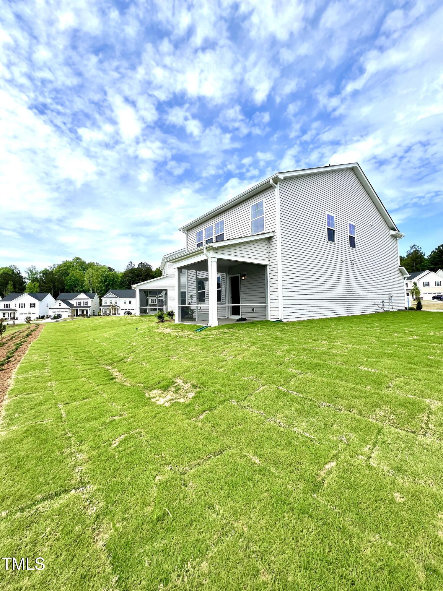 429 Lily Grv Loop Raleigh, NC 27610 - Photo 29 of 32 a view of a white house with a big yard
