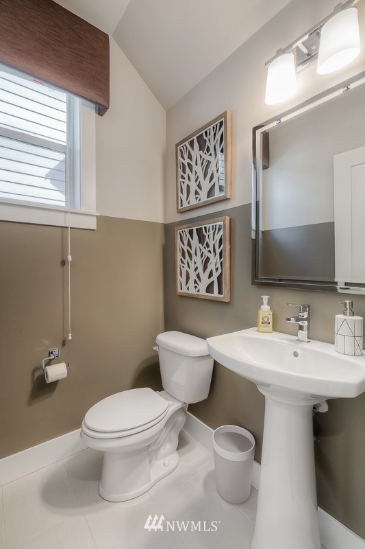 22263 9th Drive Southeast, Unit 9S Bothell, WA 98021 - Photo 4 of 25 a white toilet sitting next to a bathroom sink