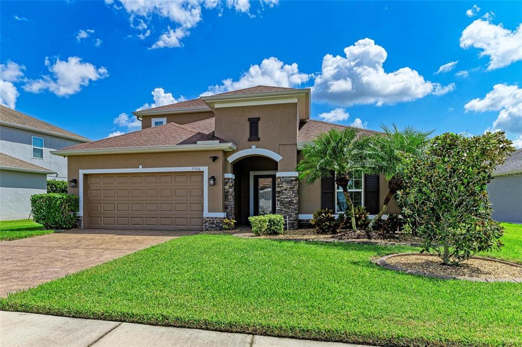 7926 111th Terrace East Parrish, FL 34219 - Photo 1 of 68 a front view of a house with a yard