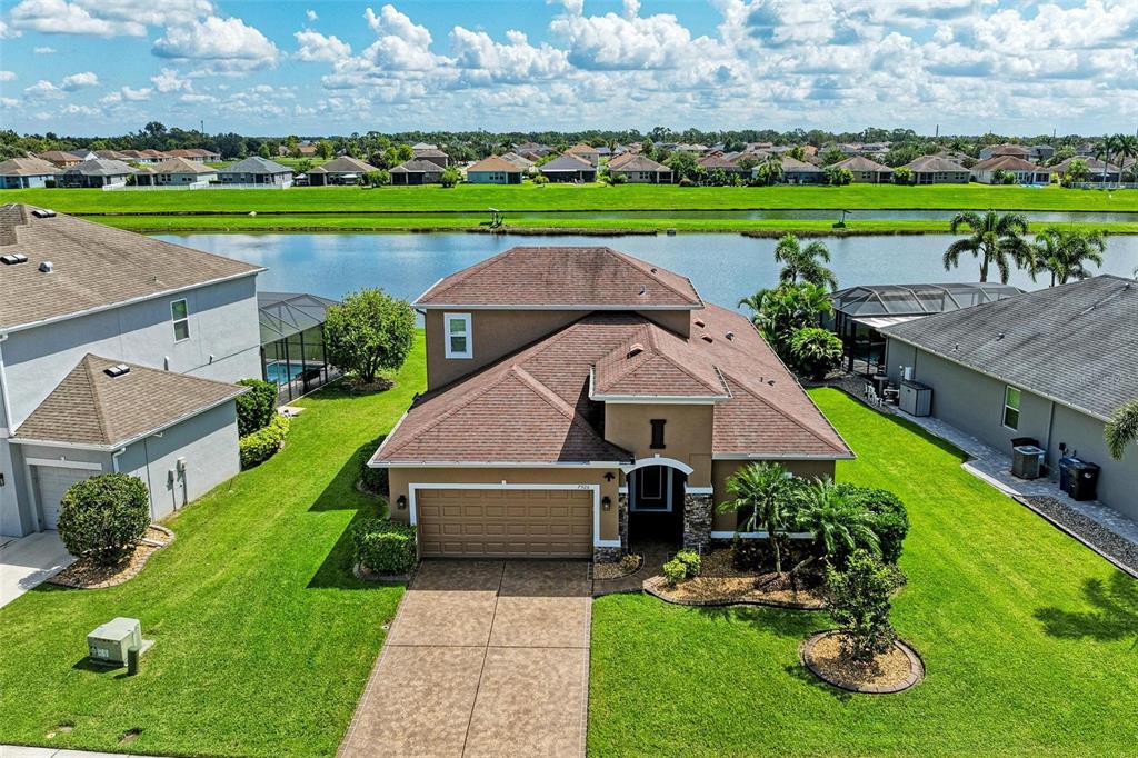 7926 111th Terrace East Parrish, FL 34219 - Photo 2 of 68 an aerial view of a house with garden space and street view