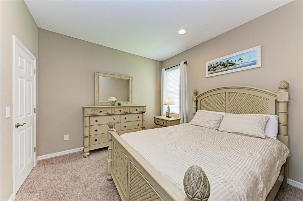 7926 111th Terrace East Parrish, FL 34219 - Photo 30 of 68 a bedroom with a bed and a table