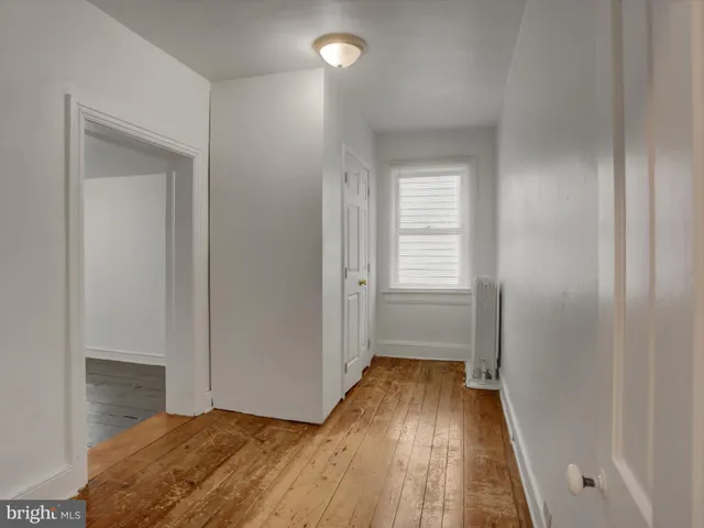 a bathroom with a sink window and a bathtub