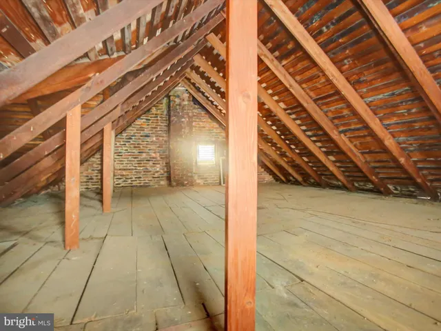 a view of a brick building with a bench in front of building