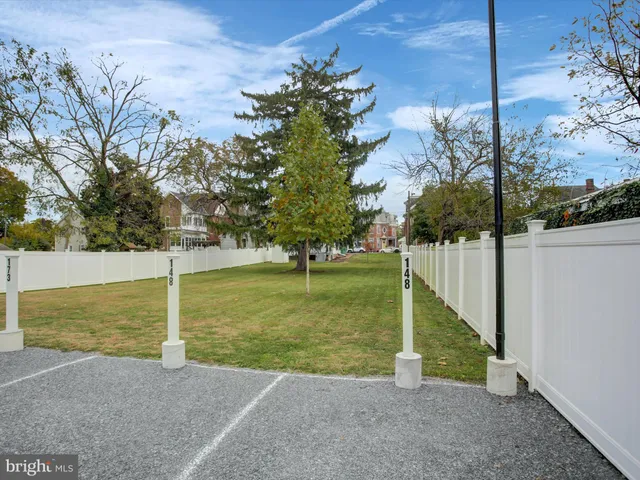 an aerial view of a house with a garden and swimming pool