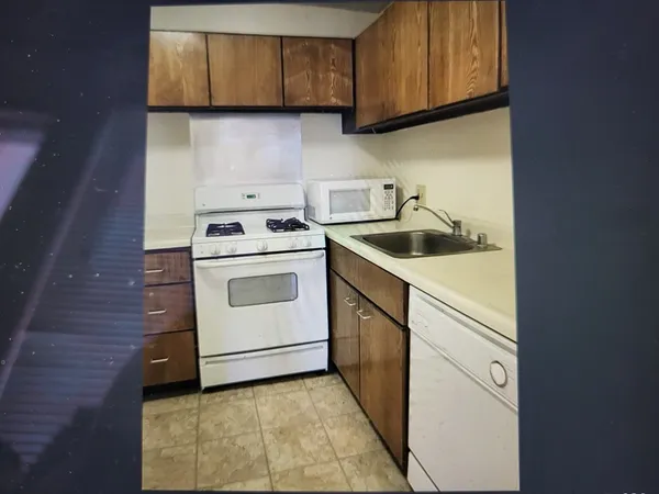 a white refrigerator freezer sitting inside of a kitchen