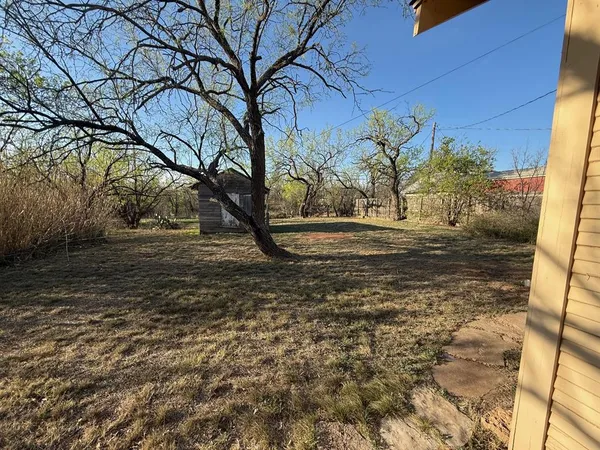 a view of a backyard of the house