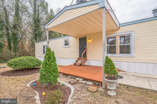 a backyard of a house with yard and outdoor seating