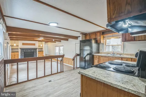 a kitchen with stainless steel appliances granite countertop a sink stove and wooden cabinets