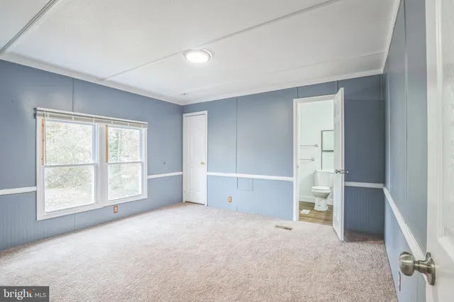 an empty room with windows and closet