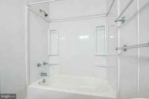 a white bath tub with a shower