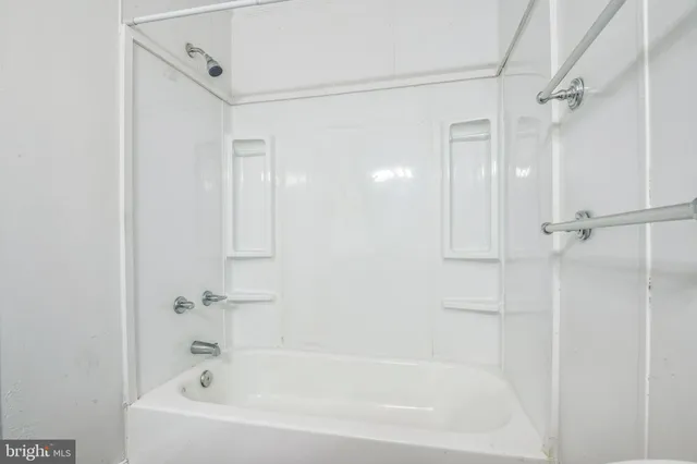 a white bath tub with a shower