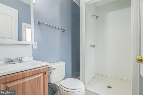 a bathroom with a shower a toilet and sink