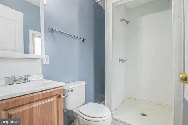 a bathroom with a shower a toilet and sink