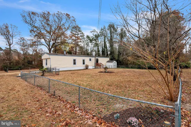 a view of a yard with snow on the road