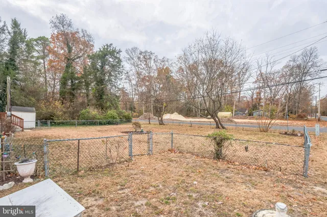 a view of yard covered with snow in front of house