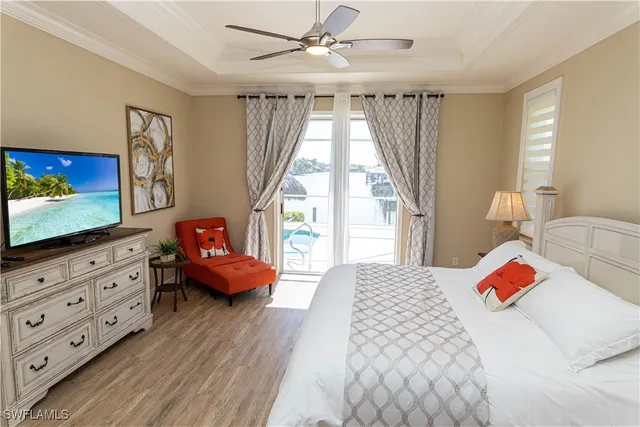 a bedroom with a bed and flat screen tv