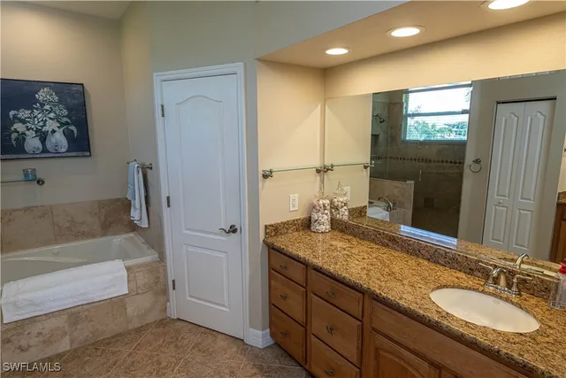 a bathroom with a granite countertop sink mirror and double